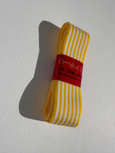 Load image into Gallery viewer, Striped grosgrain premium ribbon roll with white and bright yellow stripes. Add a pop of colour and style to elevate your gift wrapping.