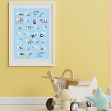 Load image into Gallery viewer, Personalised Kids&#39; Animal Alphabet Poster in a soft blue colour. Featuring watercolour animals corresponding to the alphabet. Personalised with a child&#39;s full name. Features in kid&#39;s room with yellow wall.
